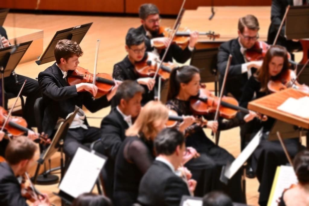 Matthew Eeuwes performing on stage with the Atlanta Symphony Orchestra